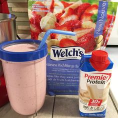 a pink smoothie in a blender next to a carton of frozen yogurt