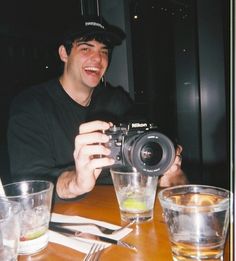 a man sitting at a table with a camera