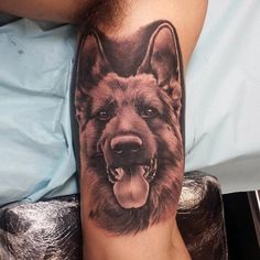 a man's arm with a tattoo of a dog on it and his tongue hanging out