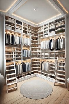 a walk in closet filled with lots of white shelves and clothes on top of them