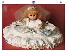 a crocheted doll is sitting on a blanket