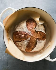 a loaf of bread in a white pot