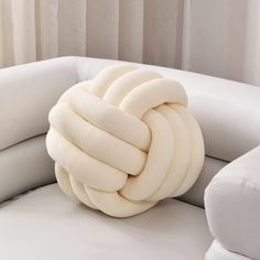 a white couch with a knot on it