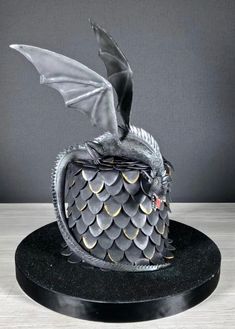 a cake that has a dragon on it with wings flying out of the top and bottom