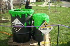 two buckets with green grass on them are sitting in the middle of a yard