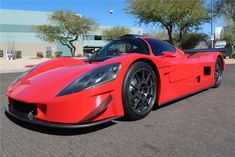 a red sports car parked in a parking lot