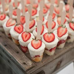 strawberries are arranged on sticks in the shape of hearts