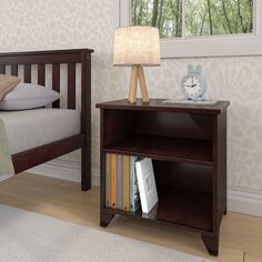 a bed room with a neatly made bed and a book shelf next to the bed