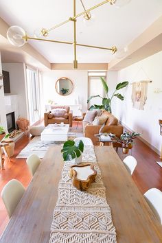 a living room filled with furniture and a wooden table in front of a fire place