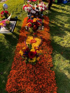 an arrangement of flowers is laid out on the grass