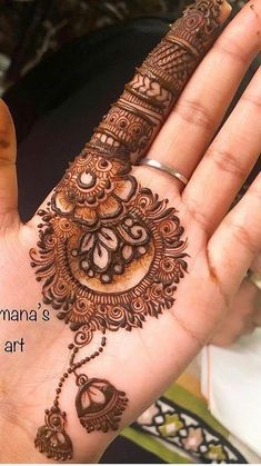 the hand is decorated with henna's intricate designs and words that spell out love