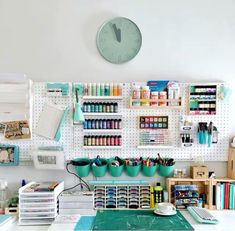 a craft room with lots of craft supplies on the wall