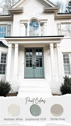 a white house with two blue doors and the words paint colors in front of it