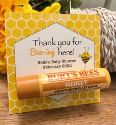 a honey themed baby shower gift with lip balm and bees on the front, thank you for beeing here