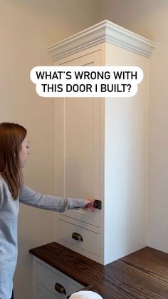 a woman standing in front of a white cabinet with the words what's wrong with this door i built?