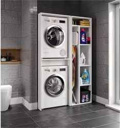 a washer and dryer in a room with tile flooring next to a toilet