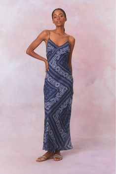 Daydreaming in the Deyo Dress. This stunning maxi debuts with a lightweight, silk habotai fabric featuring a bandana-inspired print all over. With a slightly form fitting silhouette, this slip dress begins with tiny spaghetti straps above a slight v-neckline that descends to a long, flirty skirt. Hippie Cotton V-neck Maxi Dress, Indigo V-neck Maxi Dress For Beach, Bandana Dress, Bohemian Tie-dye Maxi Beach Dress, Festival Block Print V-neck Maxi Dress, Patterned Paisley Print V-neck Maxi Dress, Thrift Inspo, Fleece Sweater, Sweater Sale