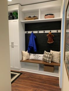 an entryway with a bench and coat rack