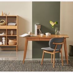 a desk with a chair and bookshelf in front of it on the floor