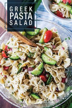 greek pasta salad with cucumbers, tomatoes and green onions in a glass bowl