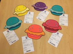 several different colored hamburgers on a table with matching cards and name tags to match them