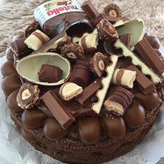 a chocolate cake topped with lots of different types of candies on top of it