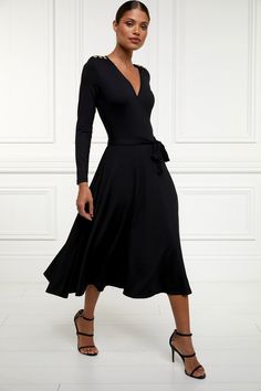 Made from sumptuously soft fabric, this dress features a double-layered design for a flattering silhouette. The wrap-across top body pairs seamlessly with a fit-and-flare skirt, creating a feminine and elegant look. With an elasticated waist for added comfort, it offers both style and ease of wear. Size & Fit Midi length Sizes XS-XL Model is 5'9" and wears size XS Details Wrap-across top Fit-and-flare skirt Signature gold hardware Double layered 96% Viscose, 4% Elastane Movie Core, Cooper Black, Wrap Dress Black, Holland Cooper, Classic Black Dress, Fit And Flare Skirt, Midi Wrap Dress, Black Wrap, Layered Design