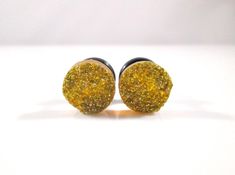 Gold Glitter Sparkle Faux Druzy Plugs Each pair is available in your choice of Acrylic Single Flared, Stainless Steel Single Flared, Stainless Steel Double Flared, or Coco Wood Double Flared Plugs. Please see Images for examples of these styles. All Listings are for one Pair. Available in 2g, 0g, and 00g Shown in 0g All Listings are for One Pair. Cheap Gold Plug Earrings For Festival, Wedding Plugs, Rose Gold Sparkle, Plug Earrings, Glitter Ornaments, Gauged Earrings, Plugs Earrings, Gauges Plugs, Glitter Makeup