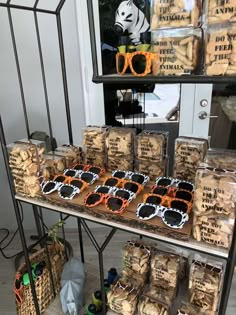 there are many items on the table for sale at this event, including sunglasses and cookies