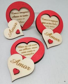 four wooden hearts with names on them