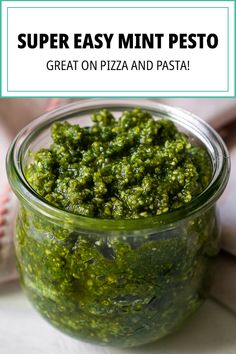 a glass jar filled with green pesto