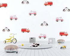 children's room with firetruck wall decals and toys on the floor