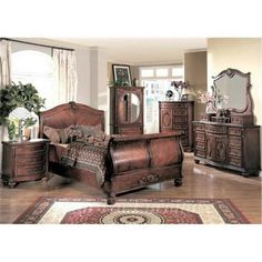 a bedroom scene with focus on the bed, dresser and armoire in the foreground