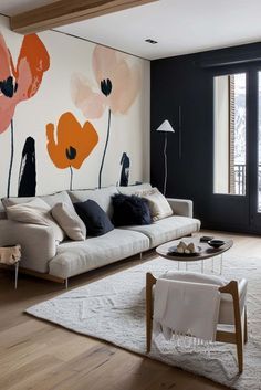 the living room is decorated with flowers and black walls, along with white rugs