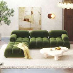 a living room with green couches and a white coffee table