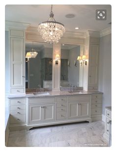 a large bathroom with double sinks and two mirrors