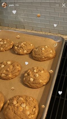 chocolate chip cookies sitting on top of a cookie sheet