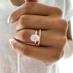 a woman's hand with a ring on it and a diamond in the middle