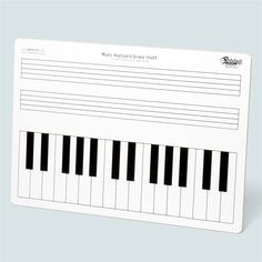 a piano keyboard is shown on a white card with black and white notes attached to it