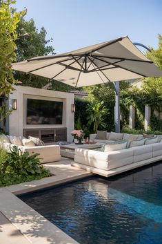 an outdoor living area with a pool and television