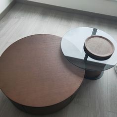 two round tables sitting next to each other on the floor