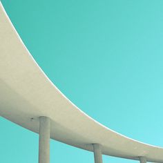 a skateboarder is doing a trick in the air on a bridge overpass