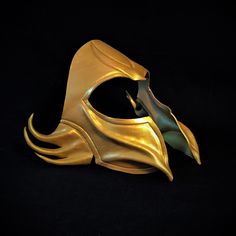 a gold mask with flames on it