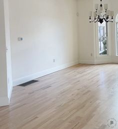 empty room with chandelier and wood flooring