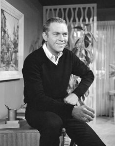 a black and white photo of a man in a living room