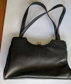 "Black leather purse in used vintage condition. Made in Korea, the label is \"Elegance by Jonatti\". It has two open pockets, one compartment with a silver toned clasp, an inner zippered pocket. It measures 12'' wide, 7'' high and 2.5\" deep, front to back.\" The kiss clasp and zipper work very well. I do ship internationally (with a few exceptions), and if I should overcharge by more than $1.00 I will refund the excess via the method you used in payment. Thank you for looking, and please come b Classic Shoulder Bag With Lined Interior For Daily Use, Formal Leather Bag With Lined Interior, Formal Rectangular Bag With Lined Interior, Formal Rectangular Shoulder Bag With Lined Interior, Formal Tote Bag With Lined Interior, Elegant Formal Shoulder Bag With Lined Interior, Evening Satchel Shoulder Bag With Leather Backing, Vintage Formal Bags With Snap Closure, Formal Leather Satchel Shoulder Bag