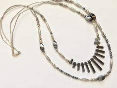 "This is a stunning vintage 1970s Native American Navajo sterling silver and hematite necklace. The necklace has two strands. The longest strand measures 30 inches the shortest strand measures 26\" The decorative hematite bead area in the front measures 3 1/2 inches and is 1 1/4\" long. It has a screw closure. There is some providence with this piece. A letter to the recipients was still with the item from the estate. It explains how she Came about purchasing the necklace as a gift. There is als Bohemian Silver Jewelry With Hematite, Double Necklace, Hematite Necklace, Hematite Beads, Square Bead, Gold Hands, Multi Strand Necklace, Strand Necklace, Multi Strand