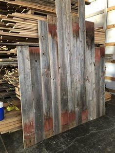 a pile of wooden pallets stacked on top of each other in a storage room