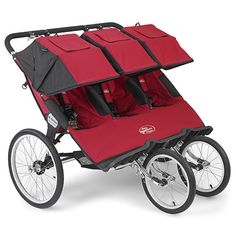 three red and black strollers with wheels on each side, facing the same direction