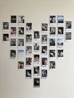 a white wall with many pictures hanging on it's side and one has a heart shaped frame in the middle